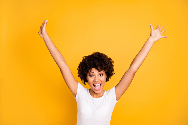 Close up photo beautiful amazing she her dark skin lady not believe yelling glad hands arms raised up great big win football team wear casual white t-shirt isolated yellow bright vibrant background - Fotoğraf, Görsel