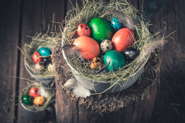 Colourfull eggs for Easter with hay in wooden cottage - Фото, зображення