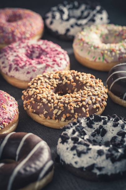 Sweet and fresh donuts with different sprinkles - Foto, Bild