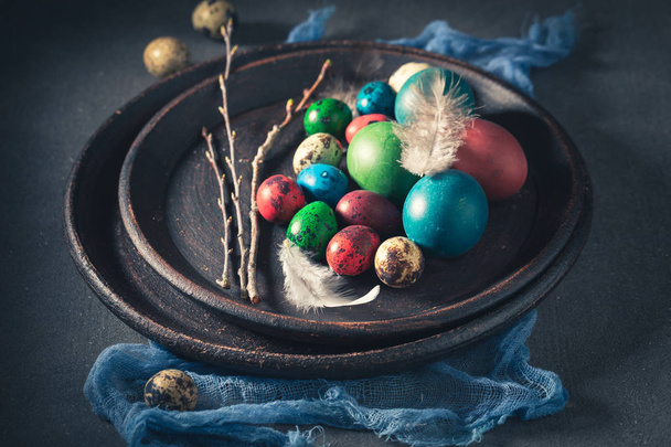 Colourfull eggs for Easter in old clay plate - 写真・画像