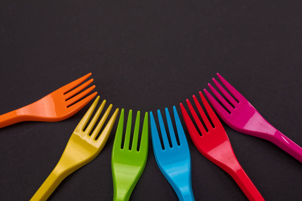 Many color plastic forks on a bright background - Photo, Image