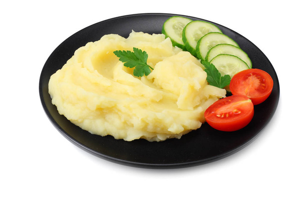 Mashed potatoes on black plate isolated on white background. - Foto, afbeelding