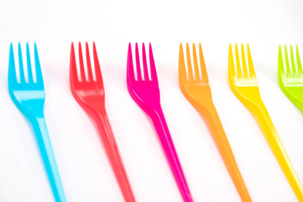Many color plastic forks on a bright background - Zdjęcie, obraz