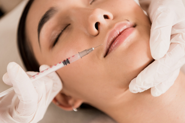 close up of beautiful asian woman getting beauty injection at clinic  - Photo, Image