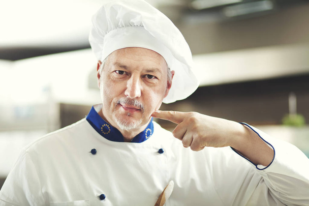 Portrait of a Chef at work in his Kitchen - Foto, Imagen
