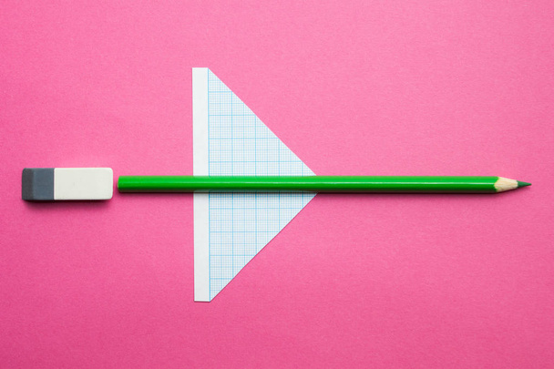 A toy airplane made of pencils on a pink background, children's creativity. Concept. - Foto, Bild