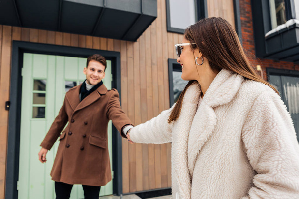 Stylish wife wearing warm beige coat asking her man to go for a walk - Φωτογραφία, εικόνα