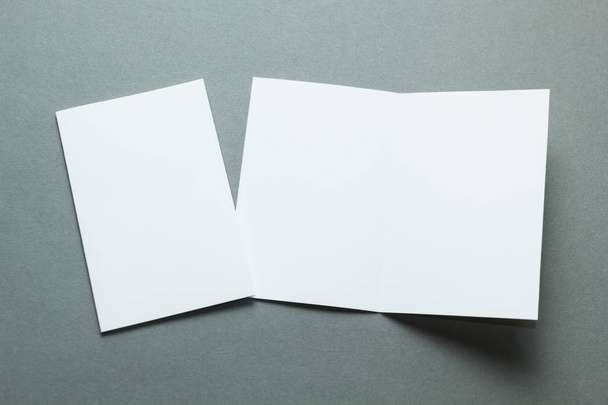 Blank white business card, postcard, flyer isolated on a grey background, mockup. - Фото, изображение