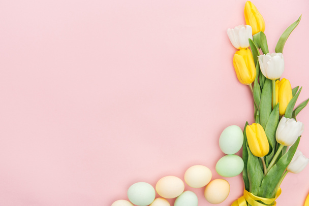 top view of tulips and pastel easter eggs isolated on pink - Photo, Image