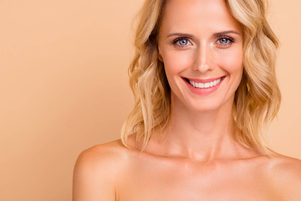 Anti age facial detox advertising concept. Close-up cropped portrait of nice attractive cheerful wavy-haired lady with perfect smooth fresh healthy shine skin isolated over beige pastel background - Photo, Image