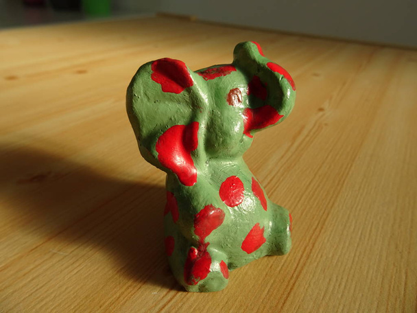 Elephant Figure with Red Dots on a Wooden Background - Φωτογραφία, εικόνα