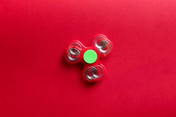 Stroboscopic photo of moving spinner on color background - Fotografie, Obrázek