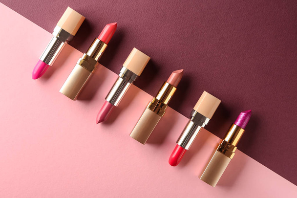Different lipsticks on color background - Фото, изображение