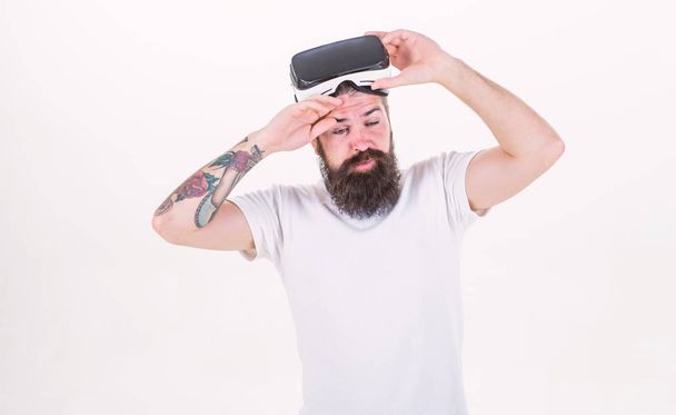 Impressive virtual reality. Man bearded hipster take off VR glasses white background. Impressed by virtual reality. Guy with head mounted display virtual reality. Hipster overwhelmed virtual reality - Valokuva, kuva