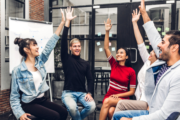 Successful of group of casual business discussing and working .creative business people celebrating with arms up in modern workloft.Teamwork concept - Photo, Image
