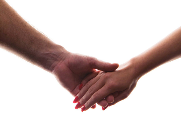 Man and woman hold hands. Close-up on a white background. - 写真・画像