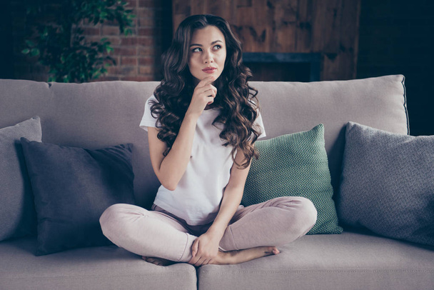 Close up portrait amazing beautiful brunette she her lady legs couch arm chin pillows think over dinner menu evening family wearing home domestic white sweatpants t-shirt outfit sit comfy divan - Fotografie, Obrázek