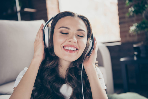 Close up portrait beautiful brunette she her lady listening favorite songs soundtrack having fun free time eyes closed wearing sporty domestic light color t-shirt pants clothes outfit comfy divan - Φωτογραφία, εικόνα