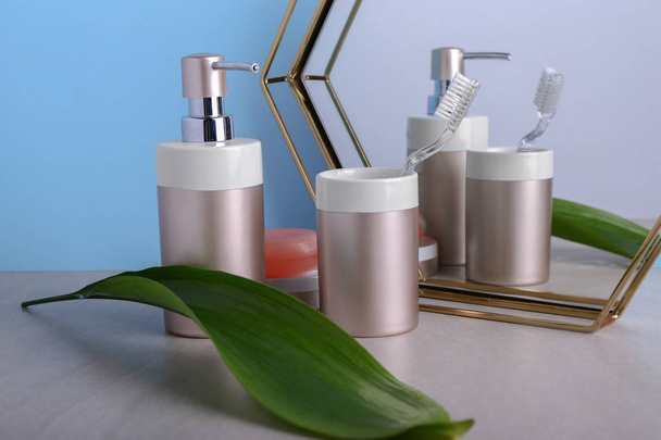 Toiletries with tropical leaf on grey table - Foto, Imagem