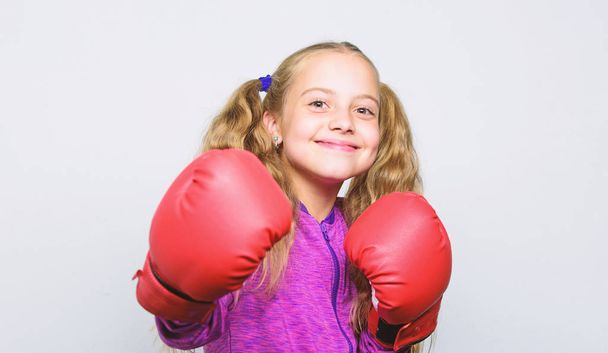 Boxing sport for female. Sport upbringing. Skill of successful leader. Sport upbringing for leader. Girl cute child with red gloves posing on white background. Cute kid with sport boxing gloves - Valokuva, kuva