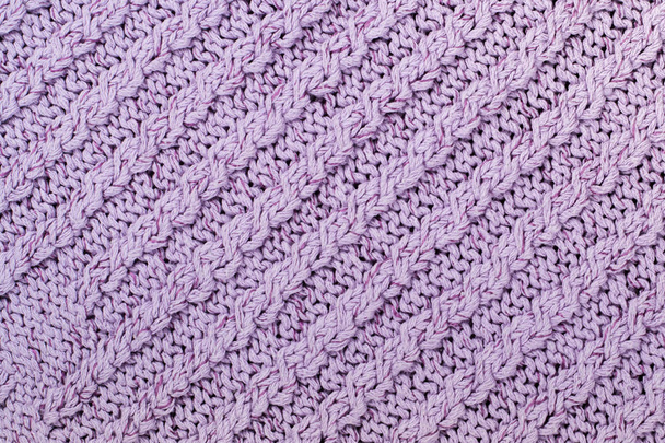 Sweater or scarf fabric texture large knitting. Knitted jersey background with a relief pattern. Braids in knitting . Wool hand- machine, handmade. - Photo, image
