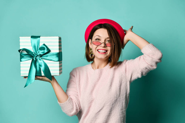 Photo of beautiful woman in felt hat holding present gift box - Foto, Imagen