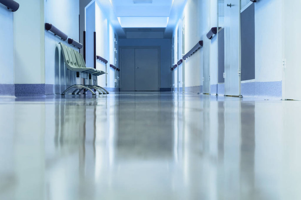 Long empty hallway with chairs in hospital. Tinted picture. - Foto, imagen