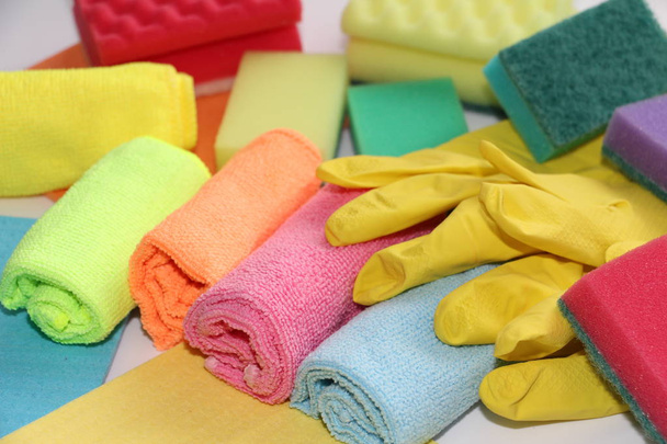 A set of tools for cleaning apartments and office. Cleaning services for cleaning. On the photo are latex gloves, sponges, microfiber cloths. - Φωτογραφία, εικόνα