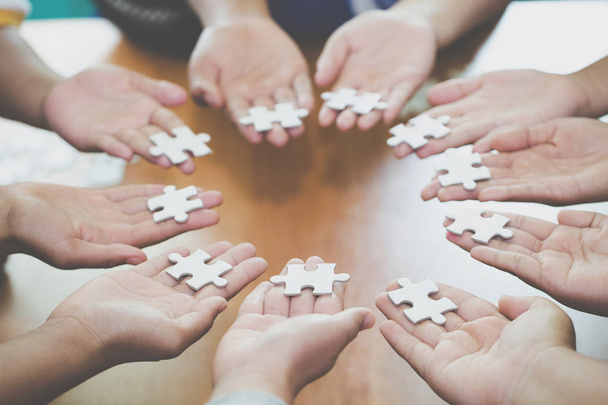 Many persons holding pieces of jigsaw puzzle,Teamwork concept,,Business connection,Success and strategy concept,Business accounting - Fotografie, Obrázek