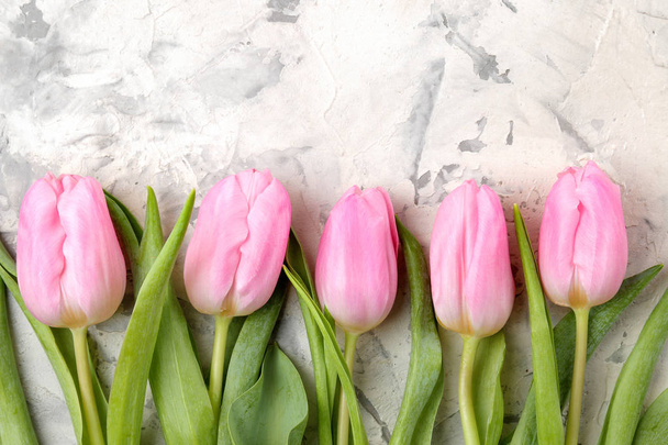 A bouquet of beautiful pink tulips flowers on a light concrete background. Spring. holidays. top view. free space - Photo, Image