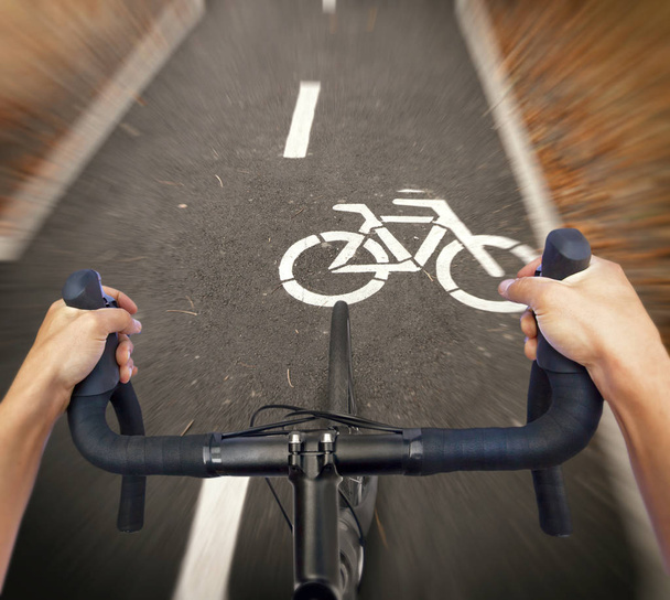 A cyclist is riding a new road bike through the cycle path - Foto, Imagen