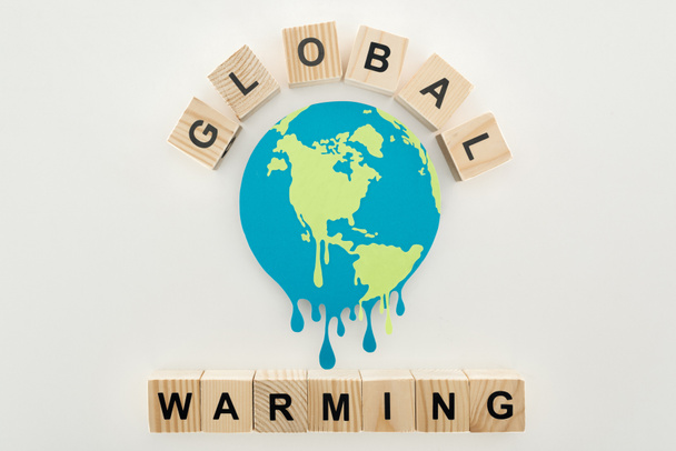 paper cut melting earth and wooden cubes with "global warming" lettering on grey background  - Photo, Image