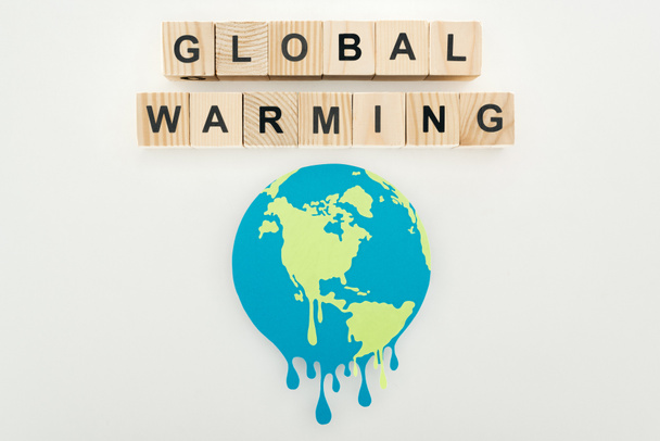 paper cut melting sign and "global warming" lettering on wooden cubes on grey background  - Фото, изображение
