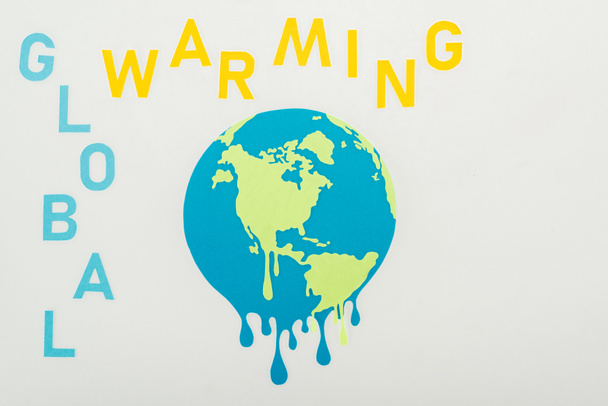 paper cut melting globe and "global warming"  inscription on grey background - Фото, изображение