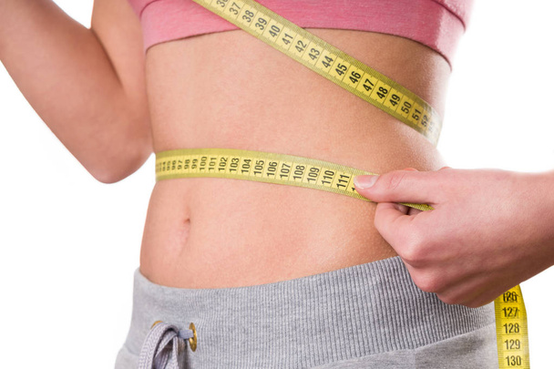 sport, fitness and diet concept, trained belly with measuring tape, health - Photo, image