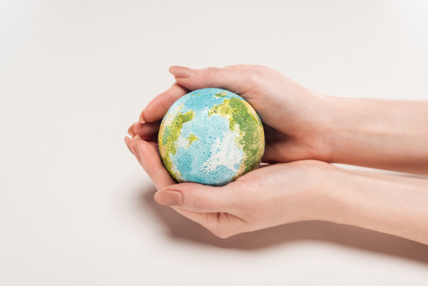 cropped view of woman holding earth model on white background, global warming concept - Fotografie, Obrázek