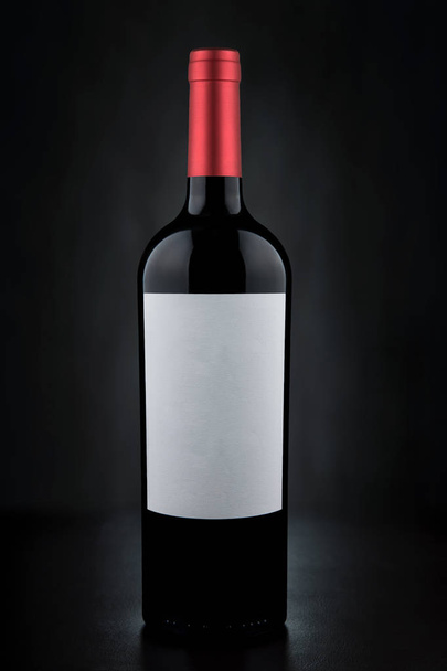 Red Wine Bottle white Label on Black Background - Photo, Image