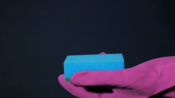 Sponge in male hand in magenta rubber glove. White foam splashes out of the spray can. - Footage, Video