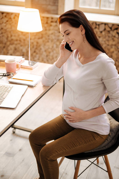 Cheerful pregnant woman using smartphone - Фото, изображение