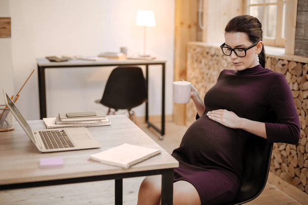 Nice pregnant businesswoman feeling discomfort - Zdjęcie, obraz