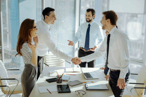 Cheerful businesspeople shaking hands with each other - Photo, Image