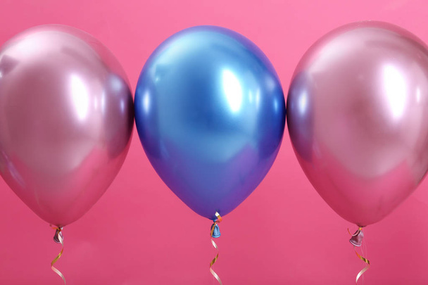 Bright balloons with ribbons on color background - Photo, Image