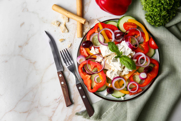 Tasty salad with feta cheese on plate - Photo, Image