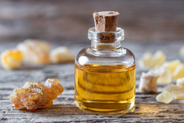 A bottle of essential oil with frankincense resin - Фото, зображення