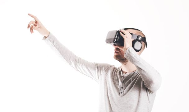 Man using virtual reality headset at white background - Zdjęcie, obraz