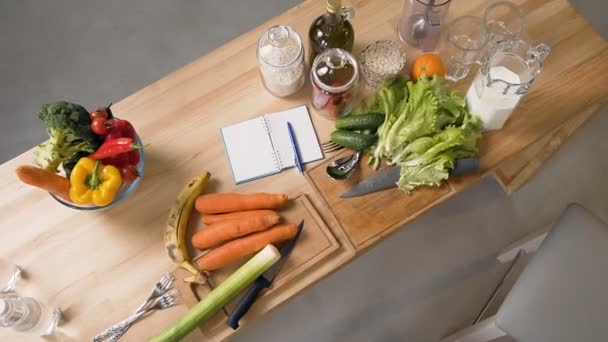 Top view of vegetables and fruits on wooden table in home kitchen. Balanced food, diet cooking and healthy lifestyle - Záběry, video