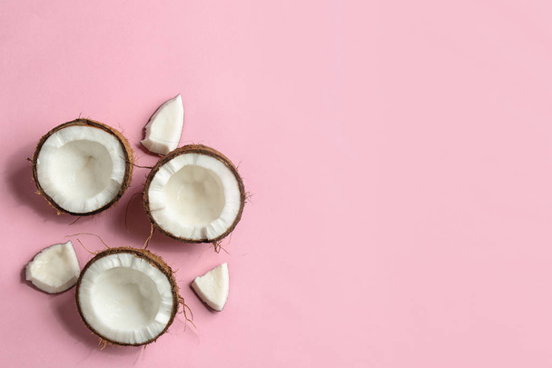 Flat lay composition with coconuts on color background. Space for text - Foto, afbeelding