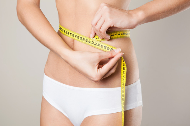 Woman measuring her waistline. Perfect Slim Body. Diet - Fotó, kép
