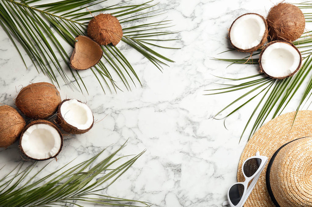 Flat lay composition with coconuts and space for text on marble background - Photo, image