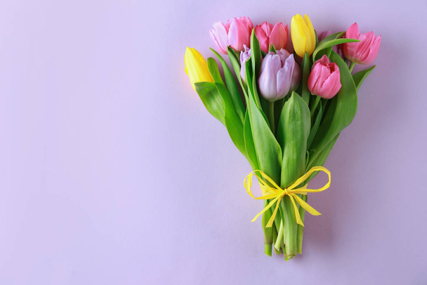 Bouquet of beautiful tulips on color background - 写真・画像